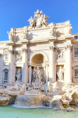 Trevi fountain in the sunshine on the first day of my Rome itinerary.