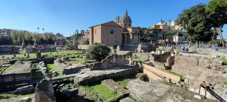 The ancient ruins of the Roman Forum viewed from Via dei Fori Imperiali.