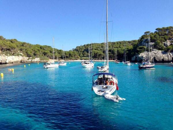 Yacht moored off a pine-clad bay on Mallorca Island.