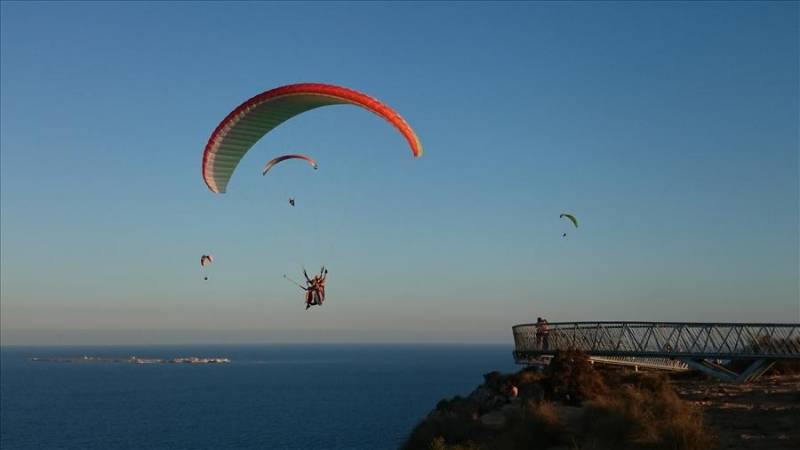 Parapenting from Santa Pola cliffs over the Mediterranean Sea in Spain.