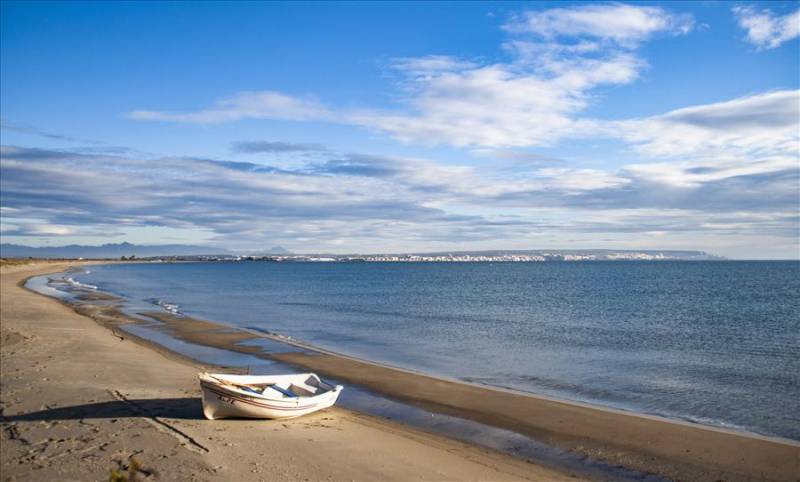 Rowing boat on the sands of La Goleta beach in Santa Pola, Spain.