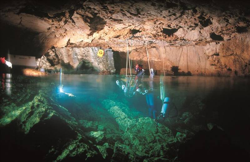 Scuba divers in Moraig Cave on the Costa Blanca in Spain.