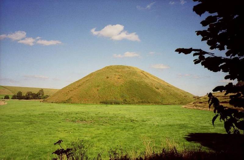 Silbury Hill 'mound' on grassland in Wiltshire.
