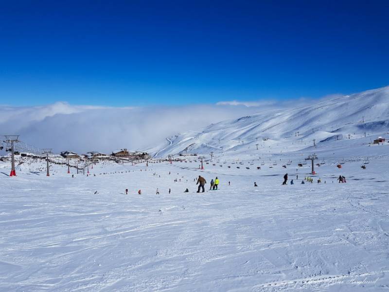 Skiers on the snowy slopes of Sierra Nevada in Spain.