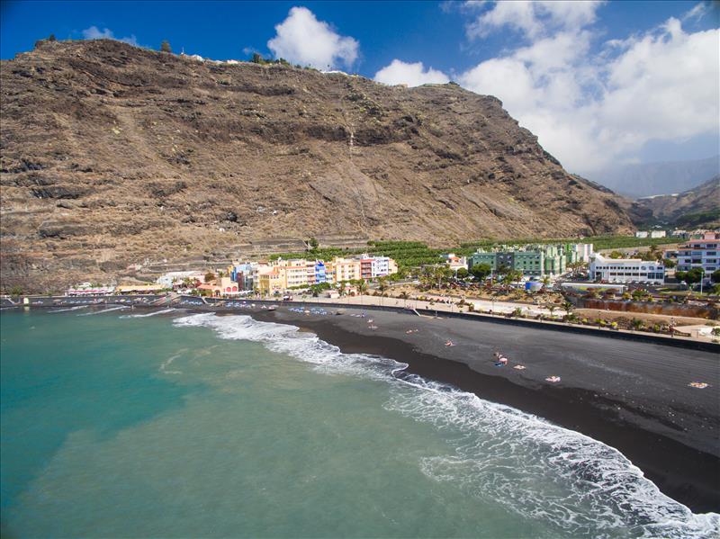 Blue sea, black sands and bright houses at Tazacorte, La Palma Island.
