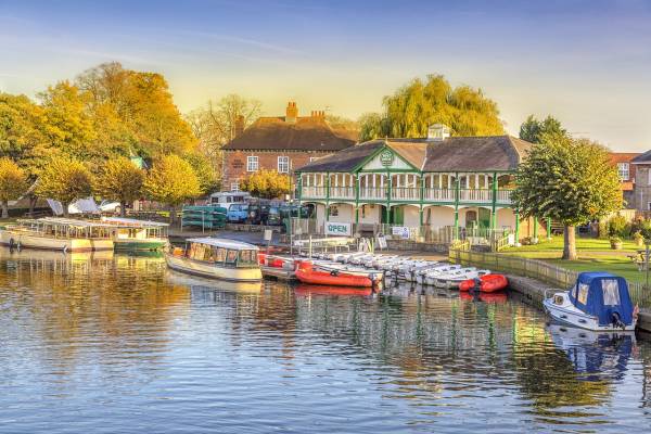 Boats on river in front of village houses in Stratford-upon-Avon.