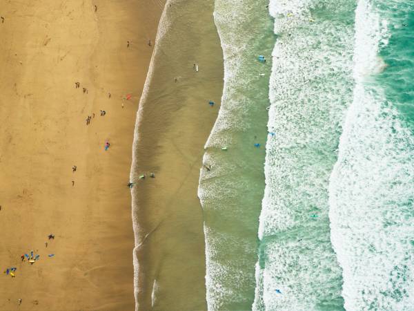 Aerial view of waves surfing to Fistral sands in Newquay, Cornwall.
