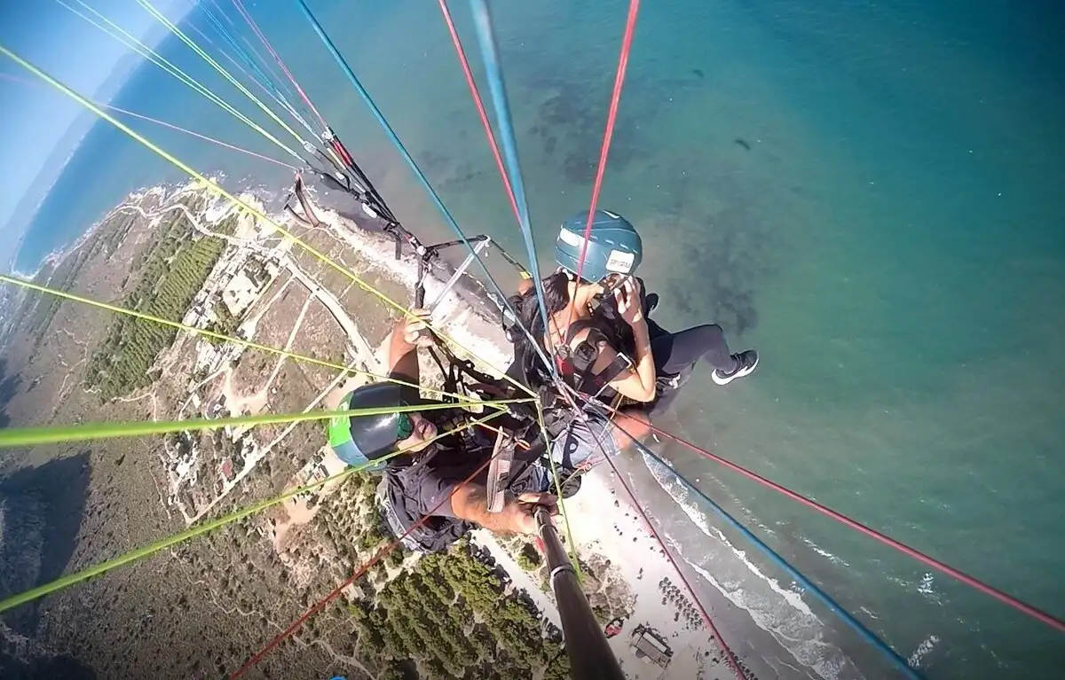 Aerial view of tandem paraglider in Alicante over the coastline and sea.