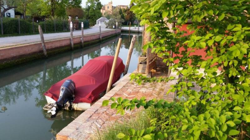 Motorboat on the canal by Torcello Venezia Villa, Venice Lagoon.