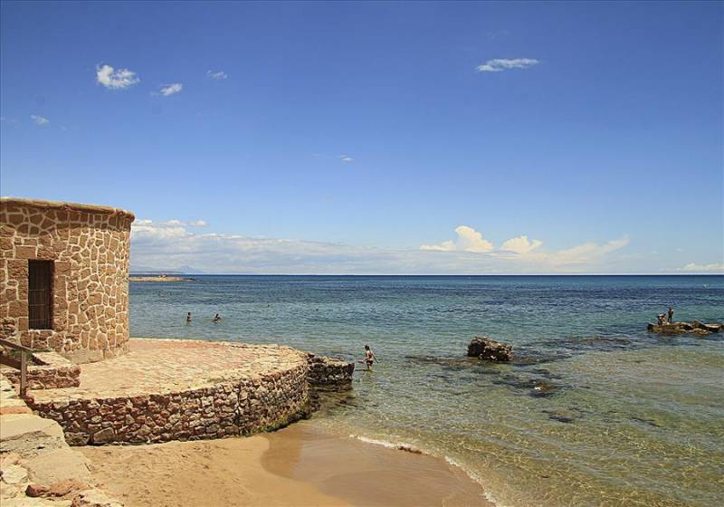 Ancient stone watchtower on La Mata Beach, Torrevieja in Spain.
