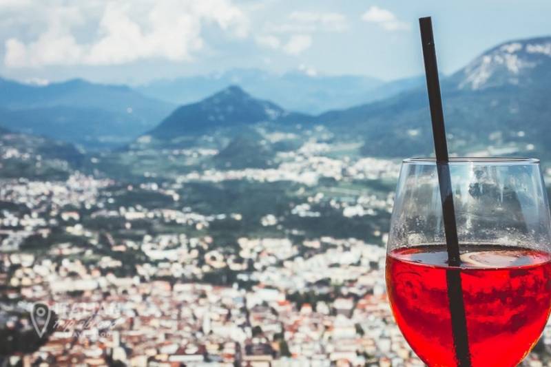 Glass of Aperol spritz  at viewpoint in Trento, Italy.