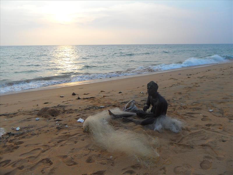 Fisherman mending a net on the Trivandrum beach in Kerala, India.