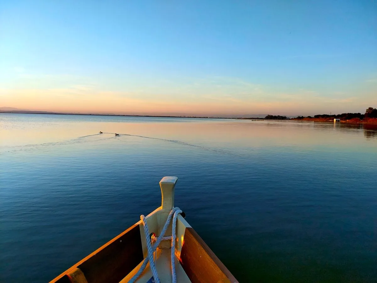 Boat trip on Albufera lake at sunset near Valencia.