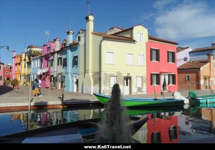 Colorful fishermen houses reflecting on a canal in Burano Island, Venice Lagoon