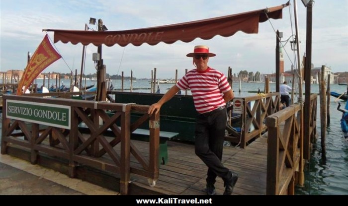 Gondolier standing by Venice Lagoon near St Mark's Square