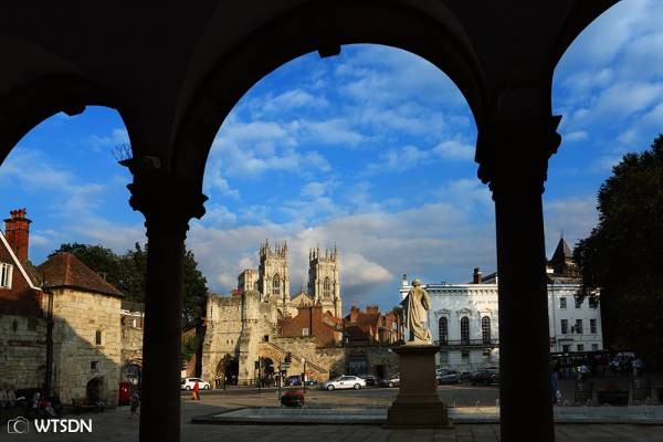 York cathedral seen through an archway on a city day trip from London.